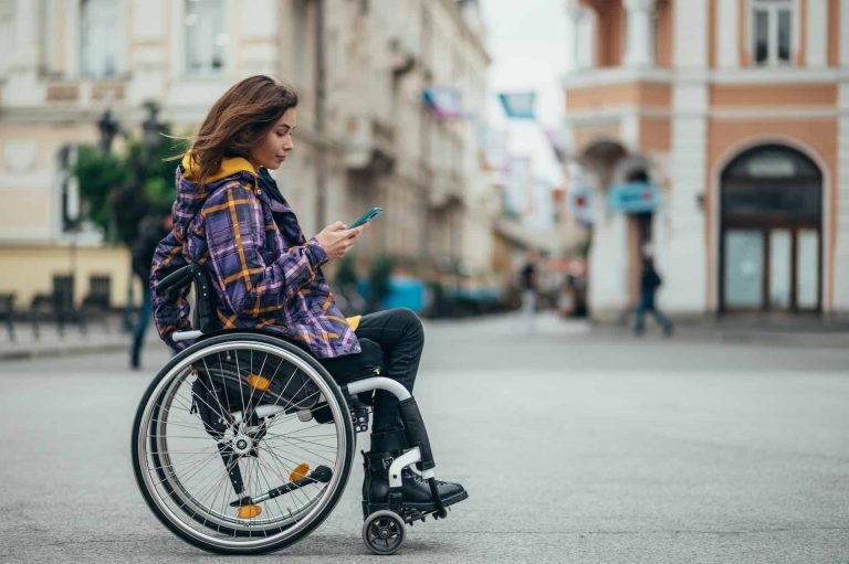 woman with disability using a smartphone while out in the city 1